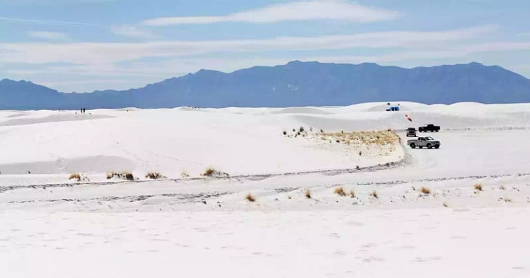 A panorama of snow at White Sands with a mountain backdrop, scenery that's one of the top reasons to go camping in New Mexico