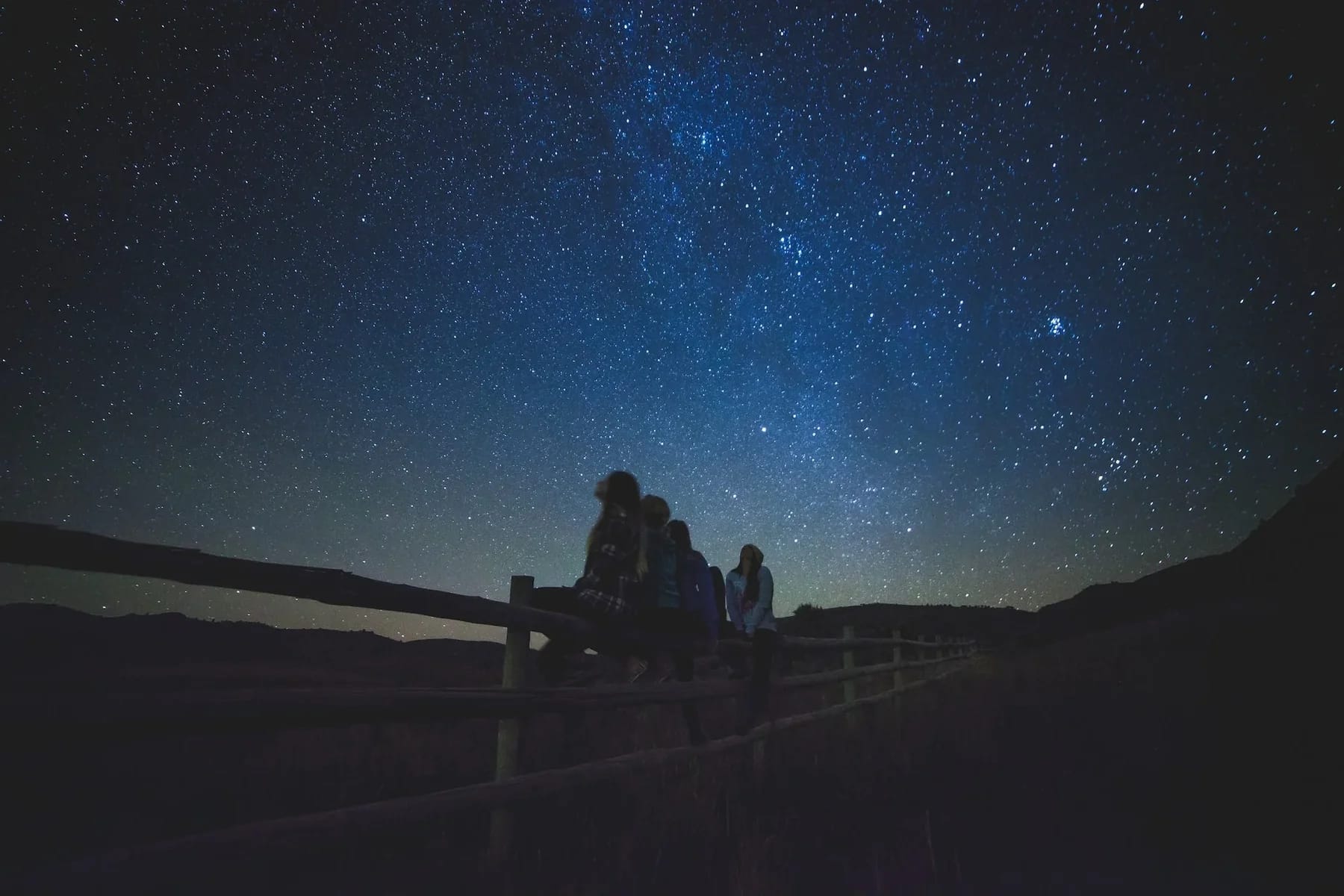 Image of family star gazing to convey astro tourism for families