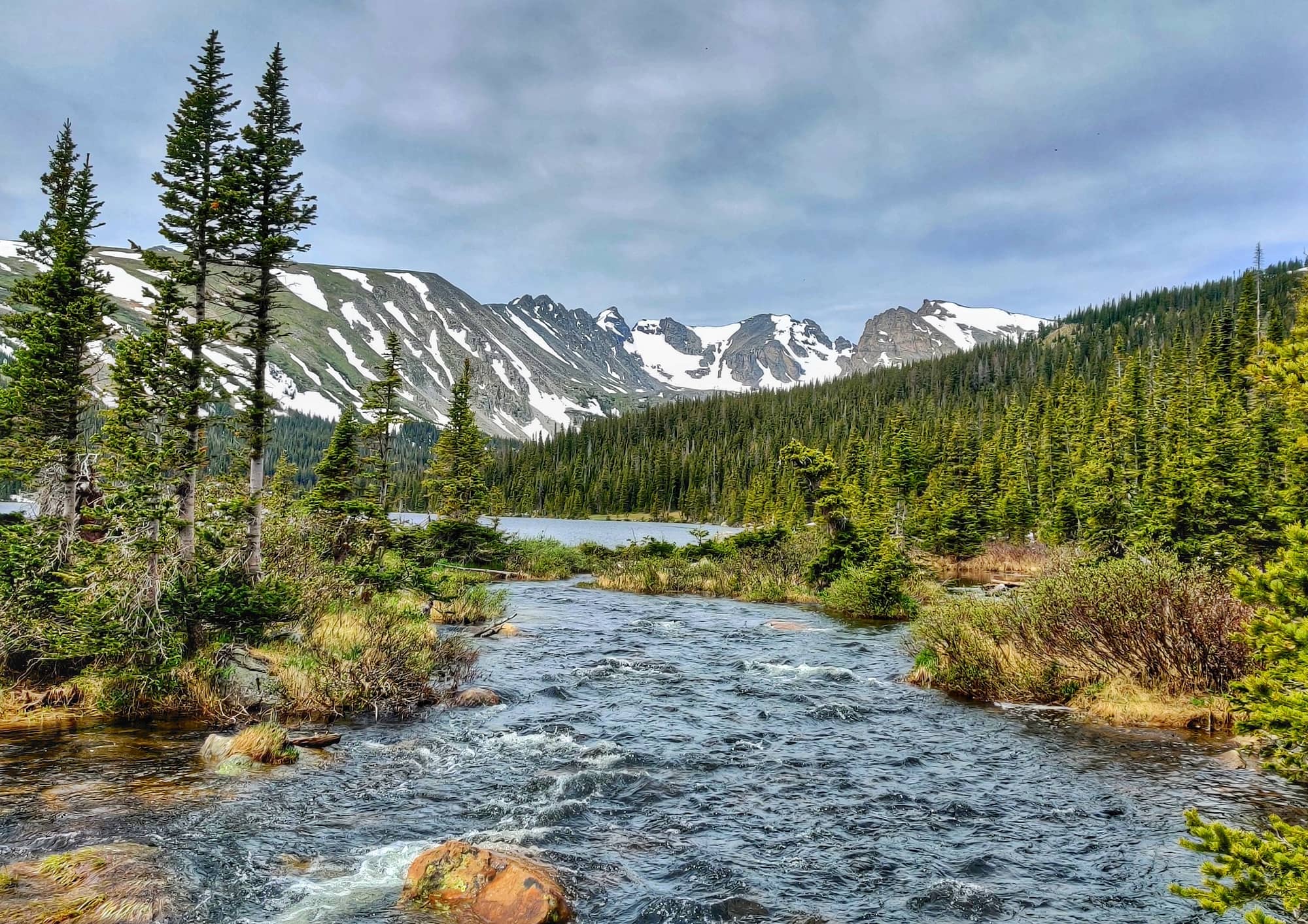 Image of Colorado mountain and creek to convey group camping in Colorado - Book Outdoors