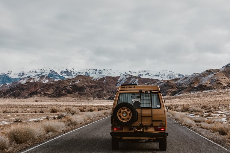 Image of a a van on a road to convey the best American roadtrips