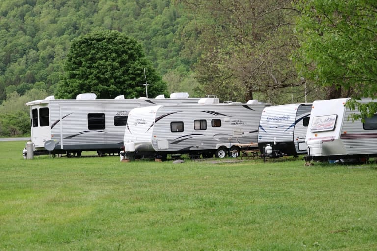 Image of RVs lined up in grass to convey Storing Your RV