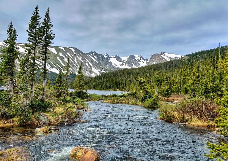 Image of Colorado mountain and creek to convey group camping in Colorado - Book Outdoors