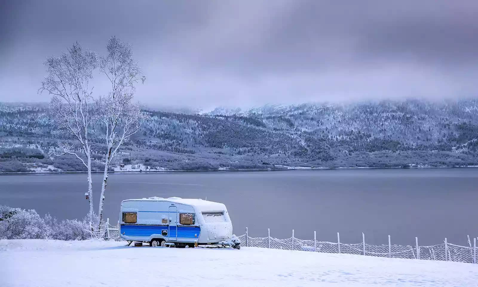 RV camping by a lake during cold winter camping in Colorado