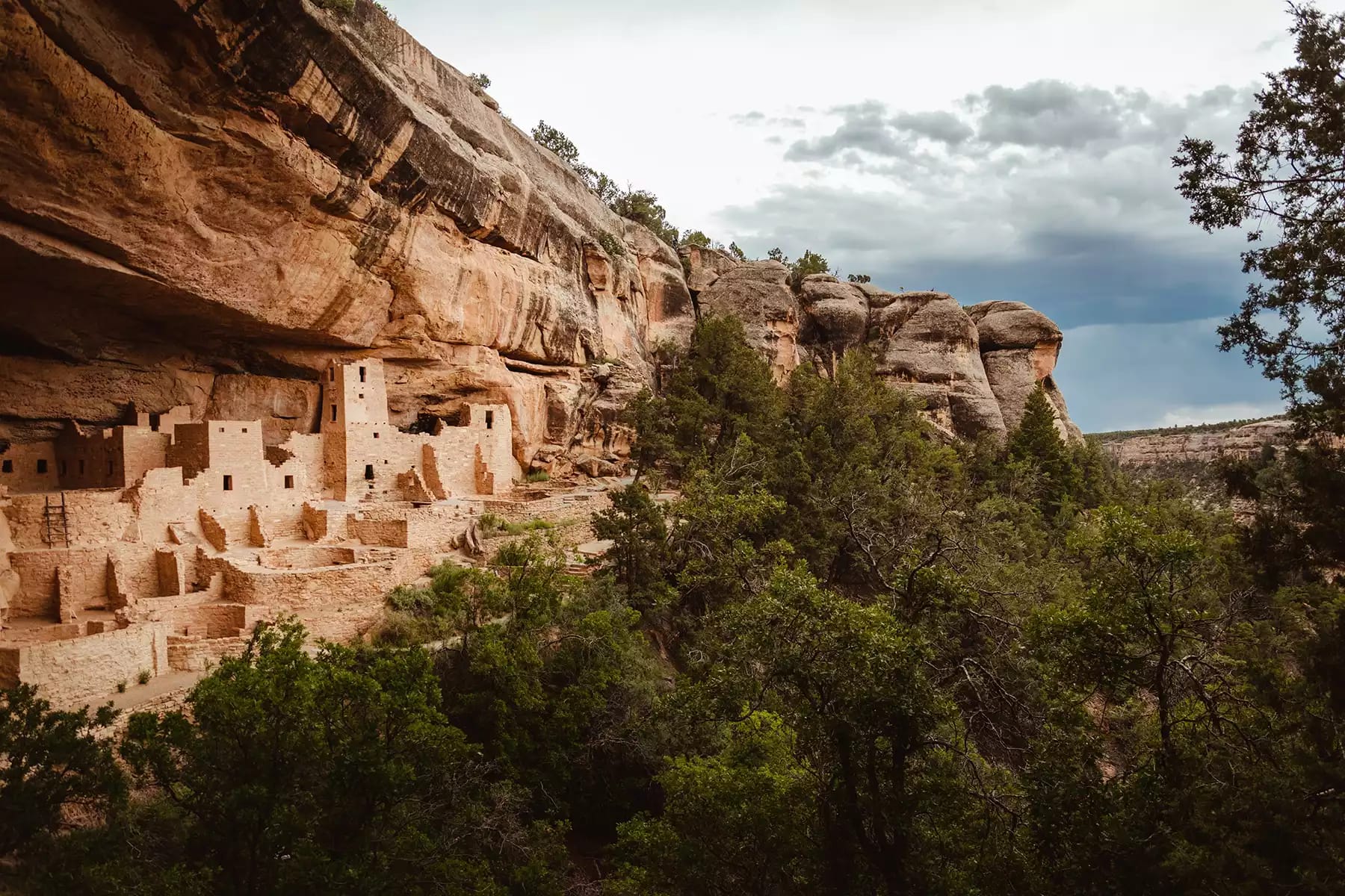 A view of ancient cliff dwellings in Mesa Verde National Park, one of the best places to visit when you travel to Colorado.