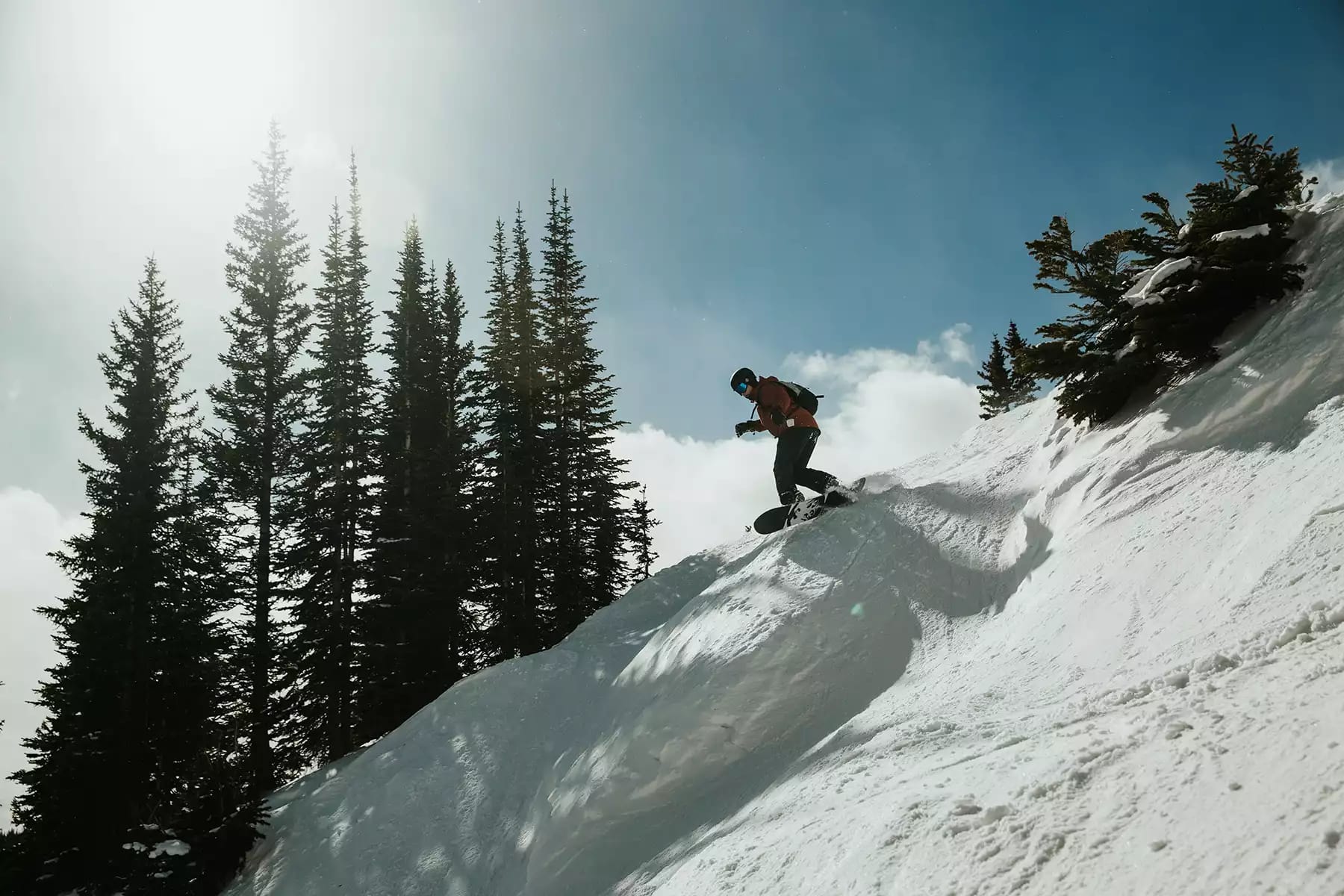 man in black jacket skiing down a mountaintop